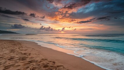 Obraz premium A tranquil beach scene featuring golden sand, gentle waves, and a stunning sunset.