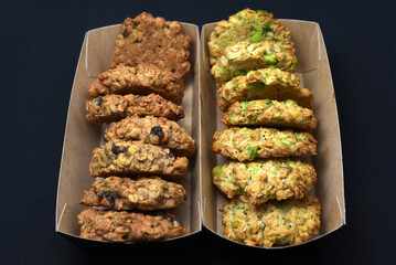 Oatmeal cookies in a box on a black background. A sweet snack.