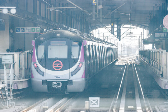 Delhi metro and the metro station. Metro rail in delhi. Dmrc metro entering the station. Indian Subway train.