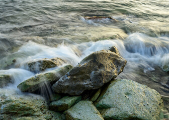 waves crashing over rocks at the shore