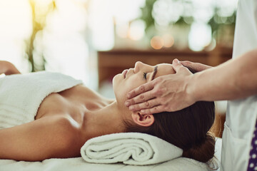 Hands, head massage and woman in spa for relax, beauty and treatment for client on bed. Towel, face and lymphatic drainage in salon by masseuse person, facial or stress relief for cosmetic therapy