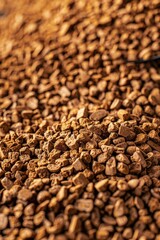 A pile of coffee beans sits on top of a wooden table, awaiting use