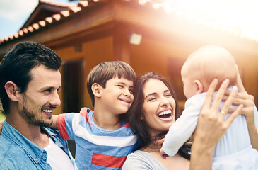 Garden, family and parents with kids, love and bonding together with happiness, lens flare and smile. Outdoor, mother and father with children, playful and fun with summer break, embrace and wellness