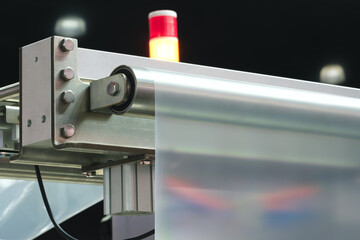 Automatic polyethylene plastic bag production machine with lighting effect. Close-up of the roller...