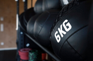 Slam ball (medicine ball) with 6kg of weight on a rack in the gym