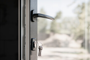 A fragment of a new plastic door with a handle in a private house