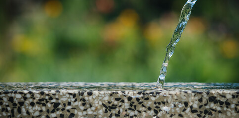 Water pours on the table in the garden