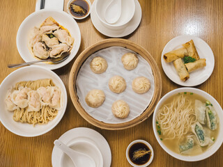 Assorted Chinese Dishes with Dumplings, Noodles, and Spring Rolls - Traditional Asian Feast
