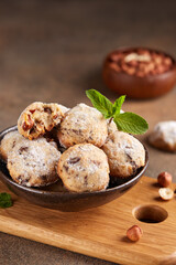 Butter cookies with hazelnuts and chocolate chips covered with sugar powder. Delicious homemade dessert.