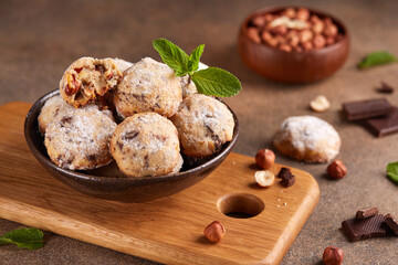Butter cookies with hazelnuts and chocolate chips covered with sugar powder. Delicious homemade dessert.