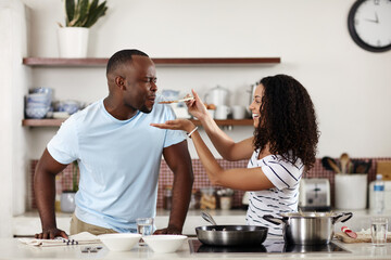 Couple, cooking and kitchen with food taste and eating at home with love, care and feeding. Healthy and happy people together in marriage with lunch, meal and smile from vegan cuisine and recipe