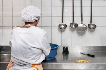 Close up of a chef in the kitchen cutting potatoes. High quality 4k footage