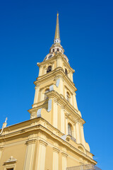 View of bell tower of Peter and Paul Cathedral with a spire, in center of Peter and Paul Fortress, at daytime, St Petersburg, Russia 