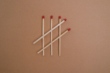 Box with new matchsticks on color background. Scattered wooden matches without a box close-up. Design
