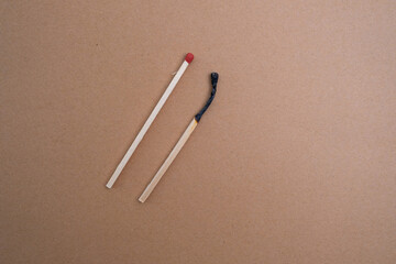 One burnt match among the whole ones. Scattered wooden matches without a box close-up. Design