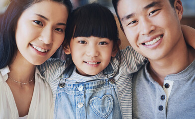 Asian family, portrait and happy in home with hug for bonding, support and relationship together. Mother, father and young girl in house with smile, trust and care for love, relax and weekend leisure