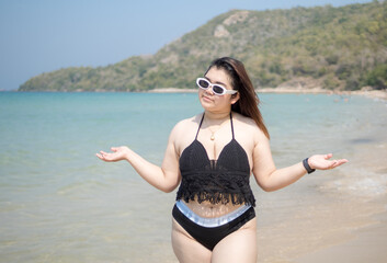 Woman young asian fat chubby cute beautiful smile happy fun enjoy relax fredom bikini swimwear body sexy front view sea beach white sand clean blue sky calm nature ocean wave water travel on holiday