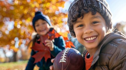 Young boy with a football in sunny autumn park. Concept of childhood, outdoor play, fall season, youth sports