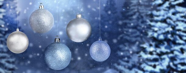 Beautiful Christmas balls against snowy forest, banner design. Space for text