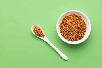 Trigonella foenum-graecum - Natural aromatic fenugreek seeds in the bowl and spoon