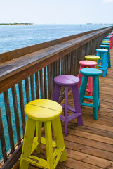 Brightly Painted Wooden Stools on Sunset Pier in Key West Florida USA