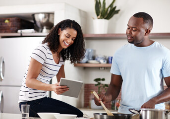 Home, kitchen and black couple with tablet for cooking, recipe website and instructions of food dish. Marriage, man cook and woman with digital for online ingredients, browse and love in house
