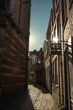 Sunlit Cobblestone Alleyway in De Wallen - Amsterdam, Netherlands