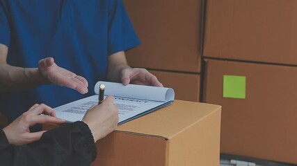 Young cheerful delivery man with parcel near car full of cardboard boxes, full length shot. Shipping service concept