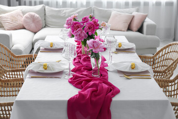Beautiful table setting with pink peonies in dining room