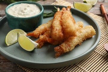 Delicious breaded fried shrimps served on wooden table, closeup