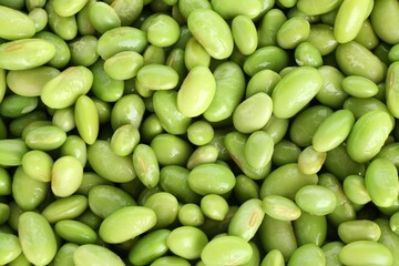 Raw green edamame soybeans as background, top view
