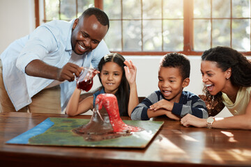 Science, parents and kids with volcano in home for school project with family bonding. Research, education and children students with mom and dad for diy 3d model of lava eruption for homework. © Hira/peopleimages.com
