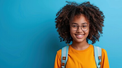 Back to school, cute black girl smiling with a backpack, glasses, plain background..