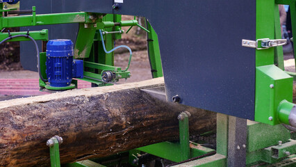 Closeup industrial saw cutting through log, themes of woodworking industry, sawmill and manufacturing. Detailing manufacturing processes involved in producing timber products.