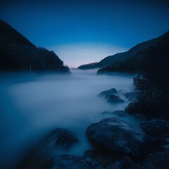 Fototapeta premium A serene dawn scene featuring a misty mountain valley, with soft blue hues enveloping the landscape. The tranquil atmosphere 