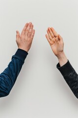 two hands clapping, one hand in dark blue sleeve and the other with light skin color wearing long sleeves, on a white background
