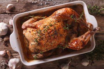 Chicken with forty cloves of garlic and ingredients close-up. horizontal top view..