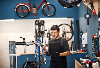 Obraz premium Bike repair, cable maintenance and man in workshop for frame building or professional engineering. Assessment, bicycle and transportation with mechanic or technician in startup for restoration