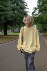 In early summer, a Japanese man in his twenties wearing yellow clothes, walking and strolling...
