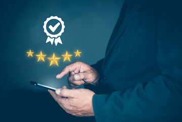 5 star rating concept of testimonial and review, people use smartphone with five star button for...