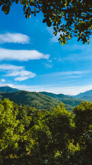 Green hilly landscape with blue sky