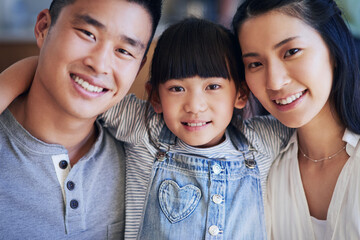 Asian family, portrait and smile in home with hug for bonding, support and relationship together. Mother, father and young girl in house with happy, trust and care for love, relax and weekend leisure