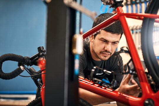 Bike repair, tablet and transport with man in workshop for frame building or professional engineering. Assessment, bicycle and maintenance with mechanic or technician in startup for restoration
