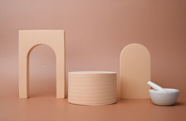 Products display podium with geometric platform and pestle and mortar for showing skincare, cosmetic and beauty products. beige background.