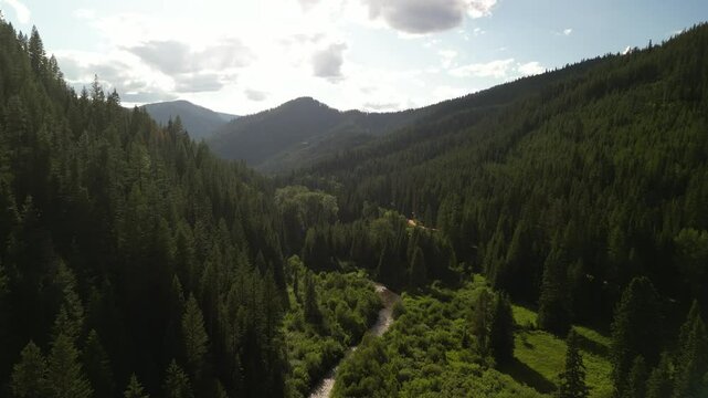 Aerial of creek and St Joe mountains at sunset in northern Idaho at sunset
