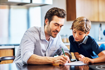 Obraz premium Dad, helping and son with homework, home and writing in kitchen, calculation and math in morning on table. House, learning and education for child, growth and development with knowledge and father