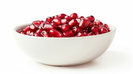 A white bowl filled to the brim with fresh pomegranate seeds isolated on a white background, showcasing vibrant red colors and healthy fruit.