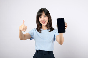 Thumb up or Approved. Asian woman showing black smartphone screen and thumb up hand gesture for approve sign advertisement isolated on white background. Recommended new application concept.