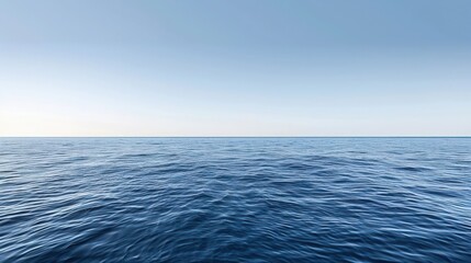 Obraz premium Serene view of a vast ocean under a clear blue sky, capturing the calm and tranquility of the endless waters and horizon.