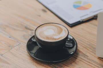 Closeup of coffee cup on table in empty corporate conference room before business meeting in office